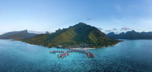 an island in the middle of a large body of water at Hilton Moorea Lagoon Resort & Spa in Papetoai