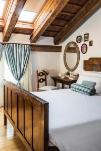 a bedroom with a large bed and a mirror at Ca' De Memi in Piombino Dese