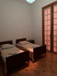 a room with two beds and a window at Maximus Wine Cellar,Bagdati Wine House in Bagdatʼi