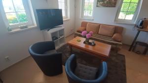 a living room with a couch and a table at Haus Rosaria in Stallhofen