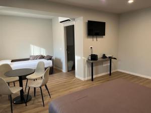 a bedroom with a bed and a table and chairs at Foiarola in Begliano