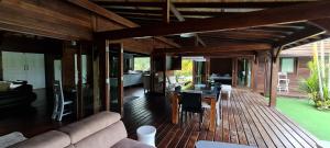 a living room and dining area of a house at Villa Totiri in Tevaitoa