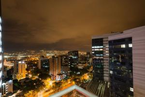 a view of a city at night at Hampton by Hilton Medellin in Medellín