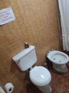 a bathroom with a white toilet and a bidet at C'Aroma de Mujer in San Salvador de Jujuy