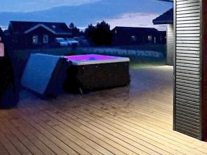 a hot tub sitting on the deck of a house at Luxury Retreat in Marielyst - By Traum Ferienwohnungen in Marielyst