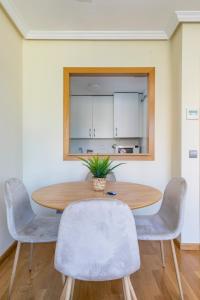 a dining room with a wooden table and chairs at Charming Nuevo Madrid in Madrid