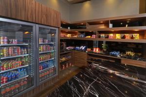 a drink bar with a refrigerator filled with lots of drinks at Hilton Garden Inn Monterrey Obispado in Monterrey