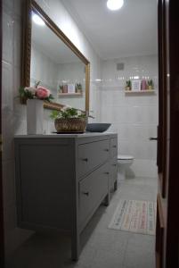 a bathroom with a sink and a mirror at ApartamentoLillos in Luanco +48 photos