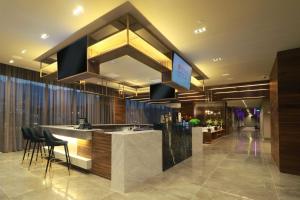 a lobby of a hotel with a counter and chairs at Hilton Garden Inn Monterrey Obispado in Monterrey +43 photos