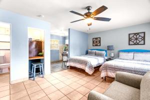 a bedroom with two beds and a ceiling fan at 11 Private Rooms Up To 47 Guests! Hotel Takeover in St. Pete Beach