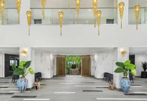 a lobby with blue and white vases and gold chandeliers at Koi Resort Saint Kitts, Curio Collection by Hilton in Basseterre