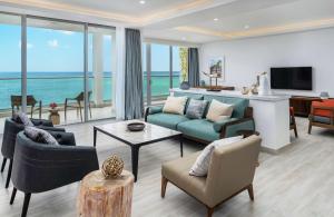 a living room with a view of the ocean at Koi Resort Saint Kitts, Curio Collection by Hilton in Basse Terre Town