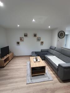 a living room with a couch and a coffee table at Maison de ville avec terrasse in Épinal