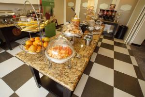 a counter with several bowls of food on it at Hampton Inn Tampico Airport in Tampico