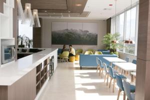 a lobby with tables and chairs in a building at Hampton By Hilton Cucuta in Cúcuta