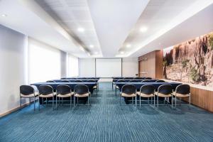 a conference room with chairs and a projection screen at Hampton By Hilton Cucuta in Cúcuta