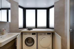 a laundry room with a washing machine and a sink at Remarkable 2-Bed Apartment in London in London