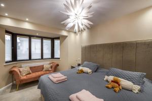 a bedroom with a large bed with two teddy bears on it at Remarkable 2-Bed Apartment in London in London