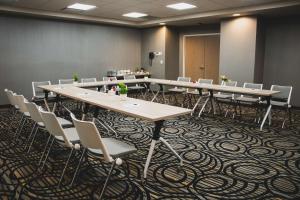a conference room with long tables and chairs at Hilton Garden Inn Leon Poliforum in León