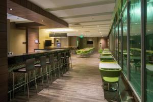 a restaurant with green and white bar stools at Hampton By Hilton Yopal in Yopal