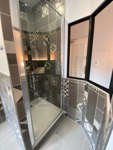a glass shower in a bathroom with a window at Château de La Dame Blanche - Logis in Geneuille