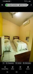 a picture of a room with two beds at Pousada Familiar Encanto da Chapada in Carolina