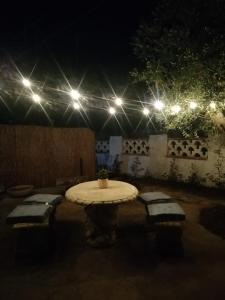 a table in a courtyard at night with lights at Villa Rebecca in Nardò +38 photos