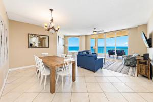 a dining room with a table and a blue couch at Beach Colony E10B in Pensacola