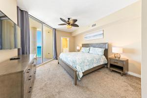 a bedroom with a bed and a ceiling fan at Beach Colony E10B in Pensacola