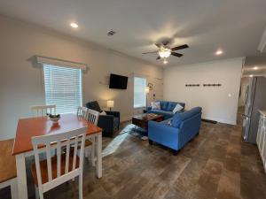 a living room with a blue couch and a table at 3bed2bath With Creek And Open Spaces in Durango