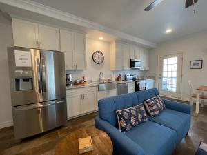 a living room with a blue couch and a kitchen at 3bed2bath With Creek And Open Spaces in Durango