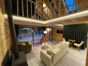 a living room with white furniture and a fireplace at IVA House in Çamlıhemşin