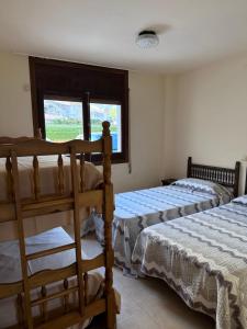 a bedroom with two beds and a window at Passeig Maritim in Miami Platja +39 photos