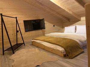 a bedroom with two beds and a flat screen tv at IVA House in Çamlıhemşin