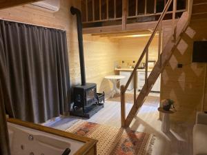 a living room with a wood stove in a cabin at IVA House in Çamlıhemşin +104 photos