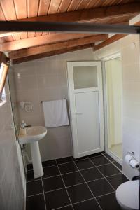 a bathroom with a sink and a toilet at Chiyanno's Inn in Dalyanköy