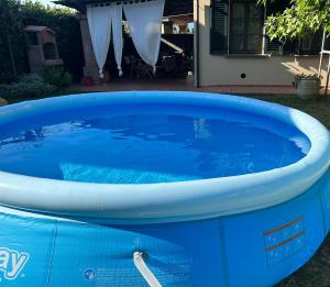 a large blue hot tub in front of a house at casa GIRASOLE in Capannori