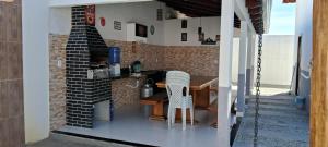 a small kitchen with a table in a house at Casa com piscina e espaço gourmet a 30m da praia! in Alcobaça