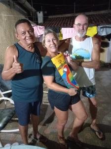 a group of three people posing for a picture at Pousada Familiar Encanto da Chapada in Carolina