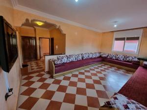 a living room with a couch and a checkered floor at Apartment in home tafraoute with terrace in Tafraoute