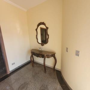 a dressing table in a room with a mirror at Hostel da Spipe in Campo Grande