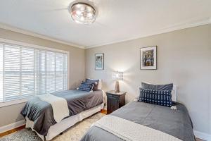 a bedroom with two beds and a window at Jump Off Rock Retreat in Hendersonville