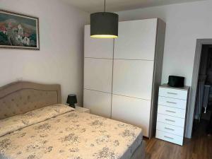 a bedroom with a bed and a large white cabinet at New apartment close to the city center! in Milan