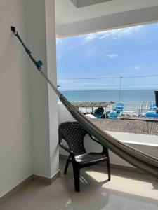 a hammock in a room with a view of the ocean at Casa grande familiar Crucita in Crucita