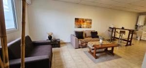 a living room with a couch and a table at Eclat Suites Hotel Boutique & Departamentos in Villa Mercedes