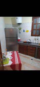 a kitchen with a refrigerator and a table in it at Appartement meublé in Meknès