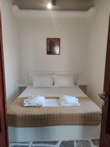 a bed with two towels on it in a room at Neo-Traditional Sunrise Apartment in Ios Chora