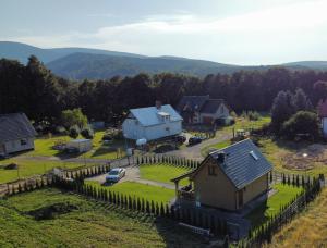 an aerial view of a village with a house and a fence at Sękowy Domek in Świeradów-Zdrój