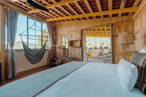 a bedroom with a large bed and a large window at Hotel Plantación in Jardin