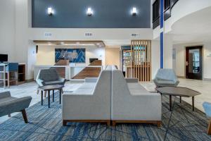 a lobby with a couch and chairs in a room at Holiday Inn Express Marietta - Atlanta Northwest, an IHG Hotel in Marietta